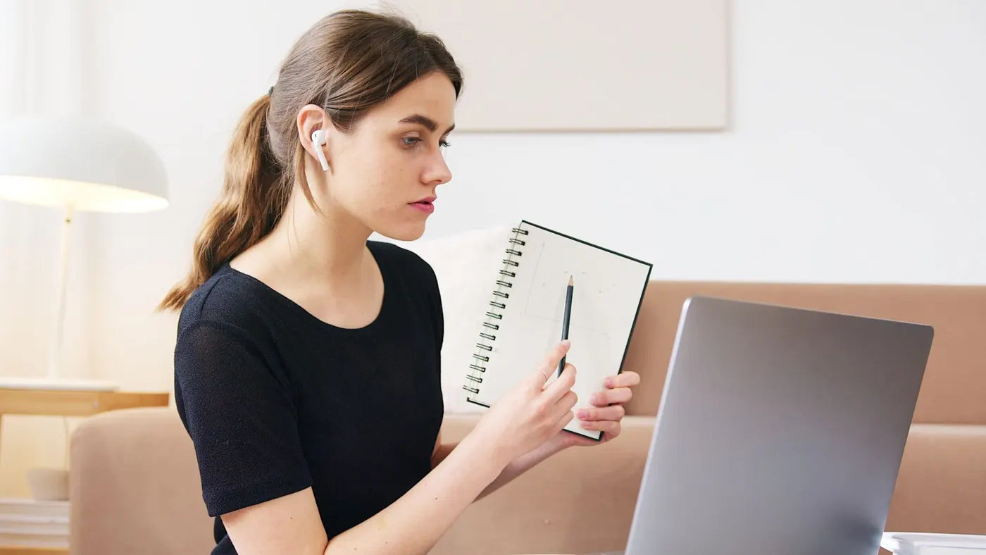 A student taking an online lesson on her laptop